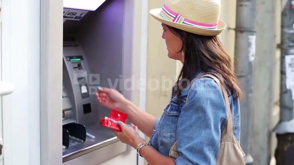 Woman gets money from ATM