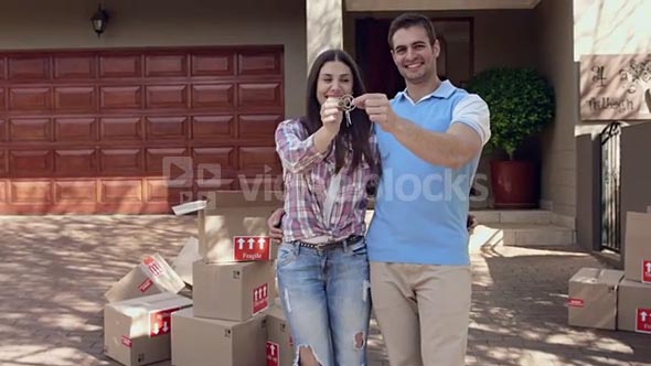 Young couple portrait smile with happiness with new house keys for their new home.