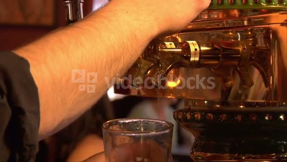 Close-up Of Beer Pouring From
