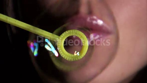 Girl Blowing Bubbles Towards the Camera