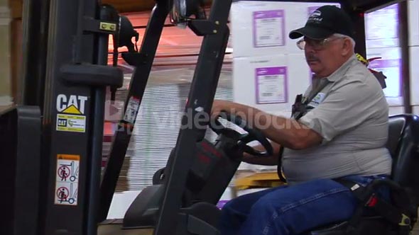Forklift Operator Drives Forklift
