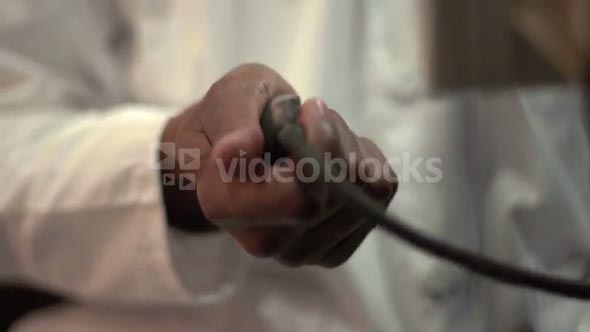 Close up of African American Doctor's hands using a sphygmomanometer to measure blood pressure