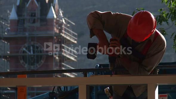 Construction Worker Uses Drill