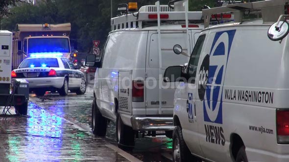 News Trucks Lined Up Behind Police Car