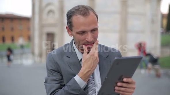 Business man in tourist city using tablet computer