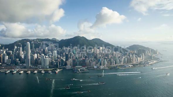 Aerial view over Hong Kong Island looking towards Victoria Peak showing the busy Victoria Harbour and Financial District of Central, Hong Kong, China, T/lapse
