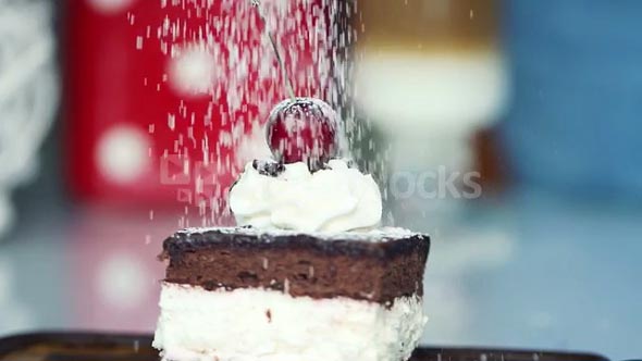 Sprinkle powder sugar on tasty cake, super slow motion, shot at 240fps