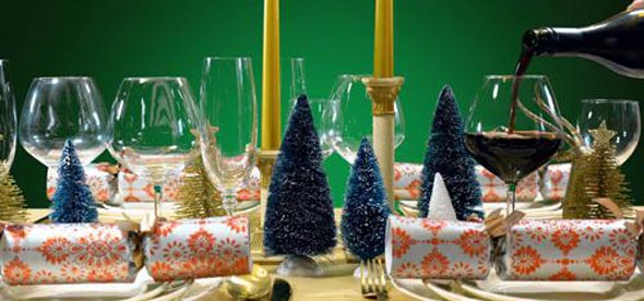 Festive Christmas lunch table in modern gold, copper, and white theme against a green background