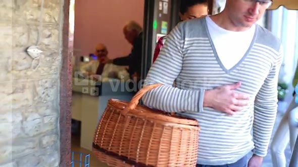 Young couple after shopping getting out of supermarket, steadicam shot