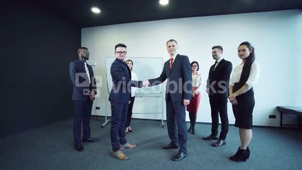 People shaking hands for the confirmation of the deal