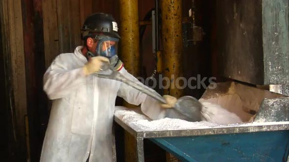 Worker With Respirator Moves Chemicals