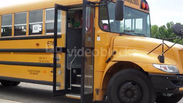 Students File Out of Bus At School