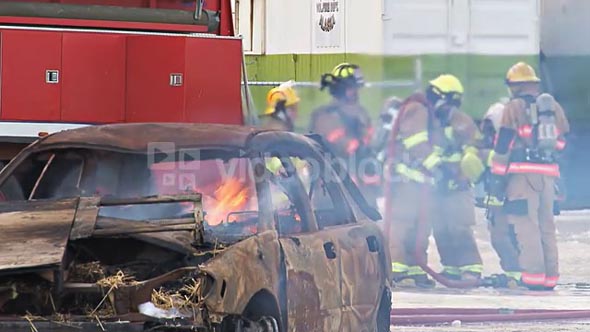 Firefighters By Flaming Car